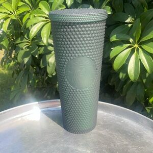 Dark green studded Starbucks cup